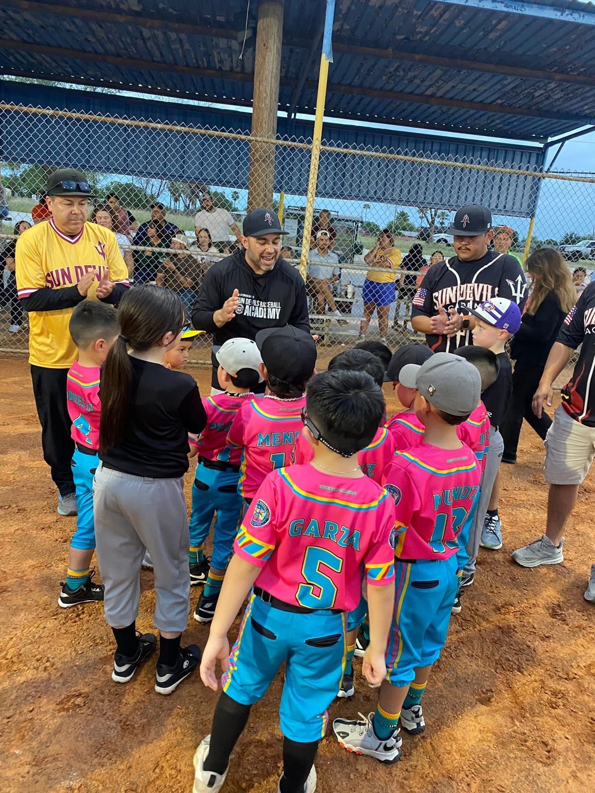 Coaches addressing young baseball players